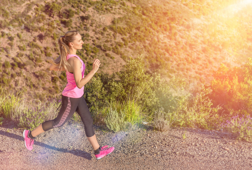 woman running on sunny trail 